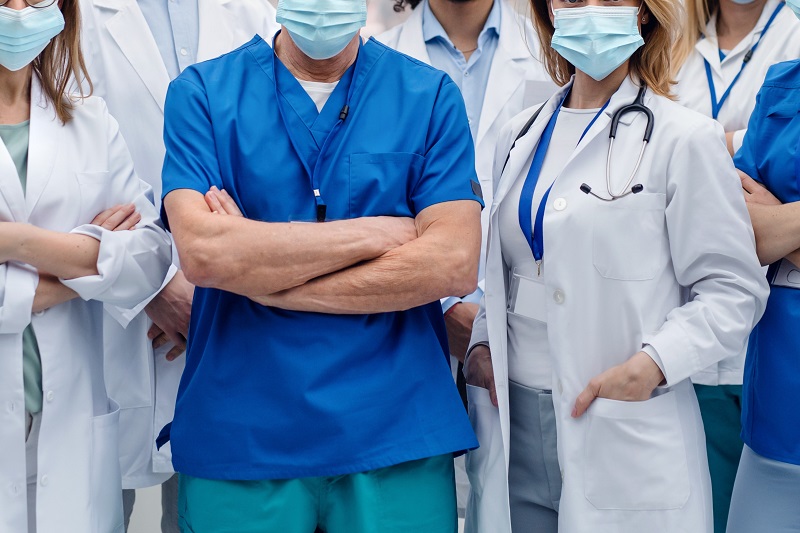 group of doctors with face masks looking at camera, corona virus concept.